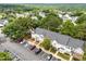 An aerial view of a townhome complex in a green, Gathering-friendly neighborhood with parking and mature trees at 5717 Corbon Crest Ln, Raleigh, NC 27612