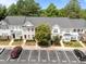 An aerial view of townhomes with ample parking in a well-maintained community with mature trees and landscaping at 5717 Corbon Crest Ln, Raleigh, NC 27612