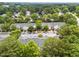 Aerial view of townhome community featuring tree lined streets and plentiful parking at 5717 Corbon Crest Ln, Raleigh, NC 27612