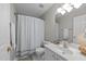 Bright bathroom with a shower-tub, white vanity, decorative towels, and neutral wall color at 5717 Corbon Crest Ln, Raleigh, NC 27612