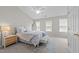 Serene bedroom boasts vaulted ceilings, plush bedding, and ample natural light at 5717 Corbon Crest Ln, Raleigh, NC 27612