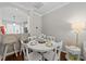 Bright dining area features a white table set for four, with barstool seating nearby at 5717 Corbon Crest Ln, Raleigh, NC 27612