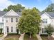 Charming townhome featuring classic architecture, lush landscaping, and a welcoming entrance for a cozy aesthetic at 5717 Corbon Crest Ln, Raleigh, NC 27612