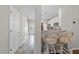 Hallway and kitchen view, featuring barstool seating and white cabinets at 5717 Corbon Crest Ln, Raleigh, NC 27612
