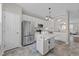 Spacious kitchen features stainless steel appliances, white cabinetry and moveable island at 5717 Corbon Crest Ln, Raleigh, NC 27612