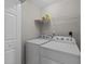 Functional laundry room with a washer, dryer, wire shelving, and ample storage space at 5717 Corbon Crest Ln, Raleigh, NC 27612