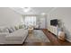 Open-concept living area with stylish furnishings and wood floors, offering a comfortable and inviting atmosphere at 5717 Corbon Crest Ln, Raleigh, NC 27612