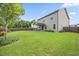 Spacious backyard with well-kept lawn, privacy fence, landscaping and covered patio at 601 Richlands Cliff Dr, Youngsville, NC 27596