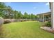 Expansive backyard with a covered patio area, green lawn, and privacy fencing at 601 Richlands Cliff Dr, Youngsville, NC 27596