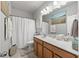 Bright bathroom featuring a single vanity with light wood cabinets at 601 Richlands Cliff Dr, Youngsville, NC 27596