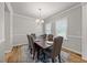 Inviting dining area with a dark wood table, upholstered chairs, and a decorative rug, creating a cozy space at 601 Richlands Cliff Dr, Youngsville, NC 27596