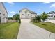 Charming two-story home with a well-manicured lawn and a long driveway leading to an attached garage at 601 Richlands Cliff Dr, Youngsville, NC 27596