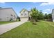 Attractive front yard featuring a lush green lawn, mature trees, and manicured landscaping enhancing the curb appeal at 601 Richlands Cliff Dr, Youngsville, NC 27596