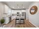 Modern kitchen featuring white cabinets, granite countertops, stainless appliances, and seating at the island at 601 Richlands Cliff Dr, Youngsville, NC 27596