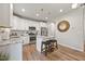 Eat-in kitchen features white cabinets, granite countertops, stainless appliances, and seating at the island at 601 Richlands Cliff Dr, Youngsville, NC 27596