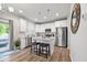 Bright eat-in kitchen features white cabinets, granite countertops, stainless appliances, and wood floors at 601 Richlands Cliff Dr, Youngsville, NC 27596