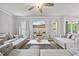 Bright living room with hardwood floors, stylish couches, a ceiling fan, and access to an outdoor space at 601 Richlands Cliff Dr, Youngsville, NC 27596