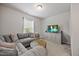 Cozy living room with gray sofa, large tv and neutral colors at 601 Richlands Cliff Dr, Youngsville, NC 27596