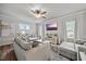 Comfortable living room with hardwood floors, stylish sofas, a ceiling fan, and a modern TV, perfect for relaxing at 601 Richlands Cliff Dr, Youngsville, NC 27596