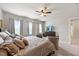 Relaxing main bedroom featuring large bed, accent chairs, and lots of light from the windows at 601 Richlands Cliff Dr, Youngsville, NC 27596