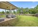 Outdoor living space featuring a covered patio with wicker furniture and a well-maintained lawn at 601 Richlands Cliff Dr, Youngsville, NC 27596