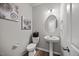 Stylish powder room featuring a pedestal sink, oval mirror, and decorative accents, creating a functional space at 601 Richlands Cliff Dr, Youngsville, NC 27596