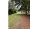 Large backyard with ample space, mature trees, green ground cover, and a shed at 603 S Third St, Mebane, NC 27302