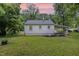 Exterior of the home showing a large, grassy backyard and covered parking area at 603 S Third St, Mebane, NC 27302