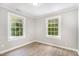 Bedroom featuring wood-look floors, neutral walls, and two windows bringing in natural light at 603 S Third St, Mebane, NC 27302