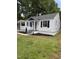 Charming home boasts a covered front porch, fresh paint, complementing navy shutters, and manicured lawn at 603 S Third St, Mebane, NC 27302