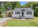 Charming home featuring a covered carport, a cozy porch and nice landscaping at 603 S Third St, Mebane, NC 27302