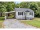 Charming home featuring a covered carport, a cozy porch and nice landscaping at 603 S Third St, Mebane, NC 27302
