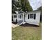 Curb appeal featuring a charming front porch, manicured lawn, and a private parking area at 603 S Third St, Mebane, NC 27302