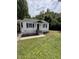 Lovely home showcasing a well-maintained lawn, and a covered parking area at 603 S Third St, Mebane, NC 27302