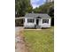 Charming home featuring a quaint front porch, white siding, and a convenient carport at 603 S Third St, Mebane, NC 27302