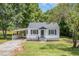 Charming home exterior with a cozy front porch, fresh paint, and inviting curb appeal at 603 S Third St, Mebane, NC 27302