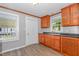 Functional kitchen with a sink, dark counter tops, and light wood cabinets at 603 S Third St, Mebane, NC 27302