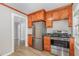 Bright kitchen boasts stainless appliances, wood cabinets, and stylish light wood floors at 603 S Third St, Mebane, NC 27302
