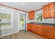 Cozy kitchen featuring warm wood cabinetry, neutral countertops and views of the backyard at 603 S Third St, Mebane, NC 27302
