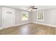 Bright living room showcasing wood-look floors, fresh paint, and natural light from two windows at 603 S Third St, Mebane, NC 27302