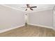 Open living room with a ceiling fan, updated light wood flooring, and fresh paint at 603 S Third St, Mebane, NC 27302