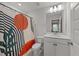 Modern bathroom with stylish shower curtain and white vanity at 627 Georgias Landing Pkwy, Raleigh, NC 27603