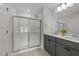 Modern bathroom featuring a glass-enclosed shower and double vanity at 627 Georgias Landing Pkwy, Raleigh, NC 27603