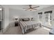 This bedroom has a ceiling fan and a door to a patio at 627 Georgias Landing Pkwy, Raleigh, NC 27603