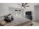 This bedroom features a TV with balcony access, providing both entertainment and outdoor enjoyment at 627 Georgias Landing Pkwy, Raleigh, NC 27603