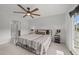 Bedroom features a ceiling fan, a large window, and an en-suite bathroom at 627 Georgias Landing Pkwy, Raleigh, NC 27603