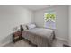 A bedroom features a window and side table at 627 Georgias Landing Pkwy, Raleigh, NC 27603