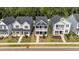 Three well-manicured two-story homes in a suburban neighborhood with sidewalks at 627 Georgias Landing Pkwy, Raleigh, NC 27603