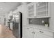Bright kitchen with stainless steel refrigerator, white cabinets, light countertops, and wood floor at 627 Georgias Landing Pkwy, Raleigh, NC 27603