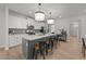Modern kitchen featuring an island with counter seating and stylish pendant lighting at 627 Georgias Landing Pkwy, Raleigh, NC 27603